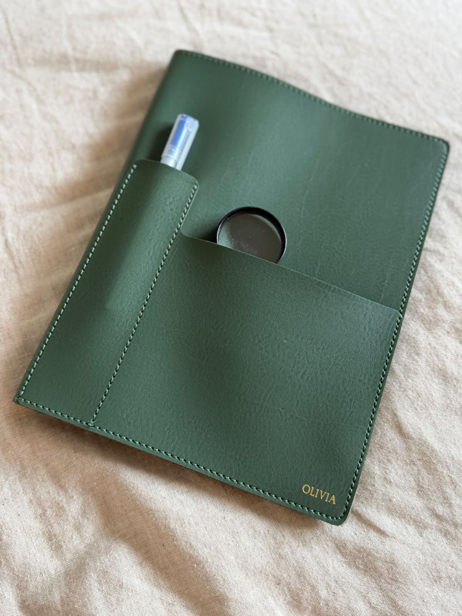 Leather cover with pen and magnifying glass in the pockets